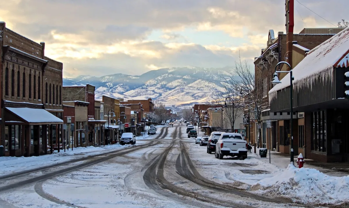 Riverton main street in snow with mountains in the distance